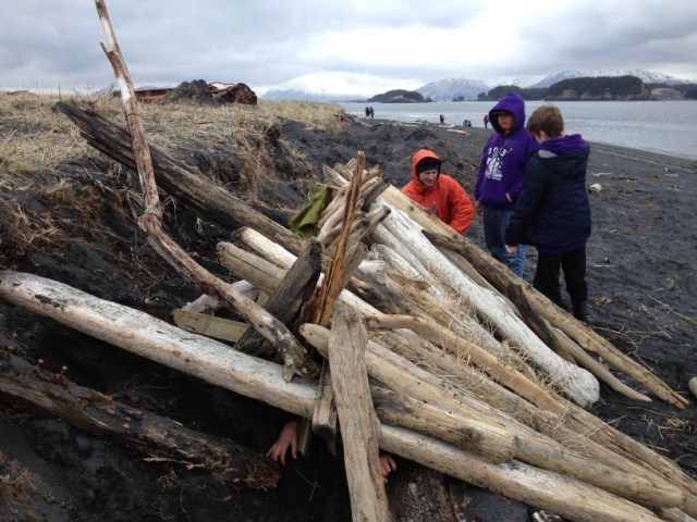 A KISAR member inspects a emergency shelter constructed by local 5th graders.