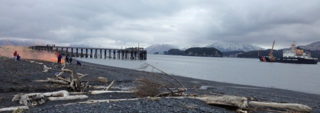 KISAR member directs school children in the use of orange smoke flares, as the USCG Spar passes nearby.